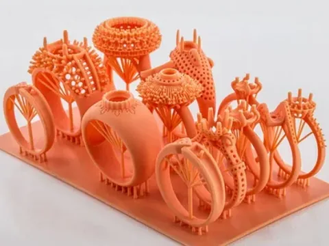 3D-printed resin models of rings on a build plate, before any metal is cast