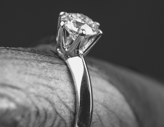 A finished solitaire ring, with its claws and setting shown close up
