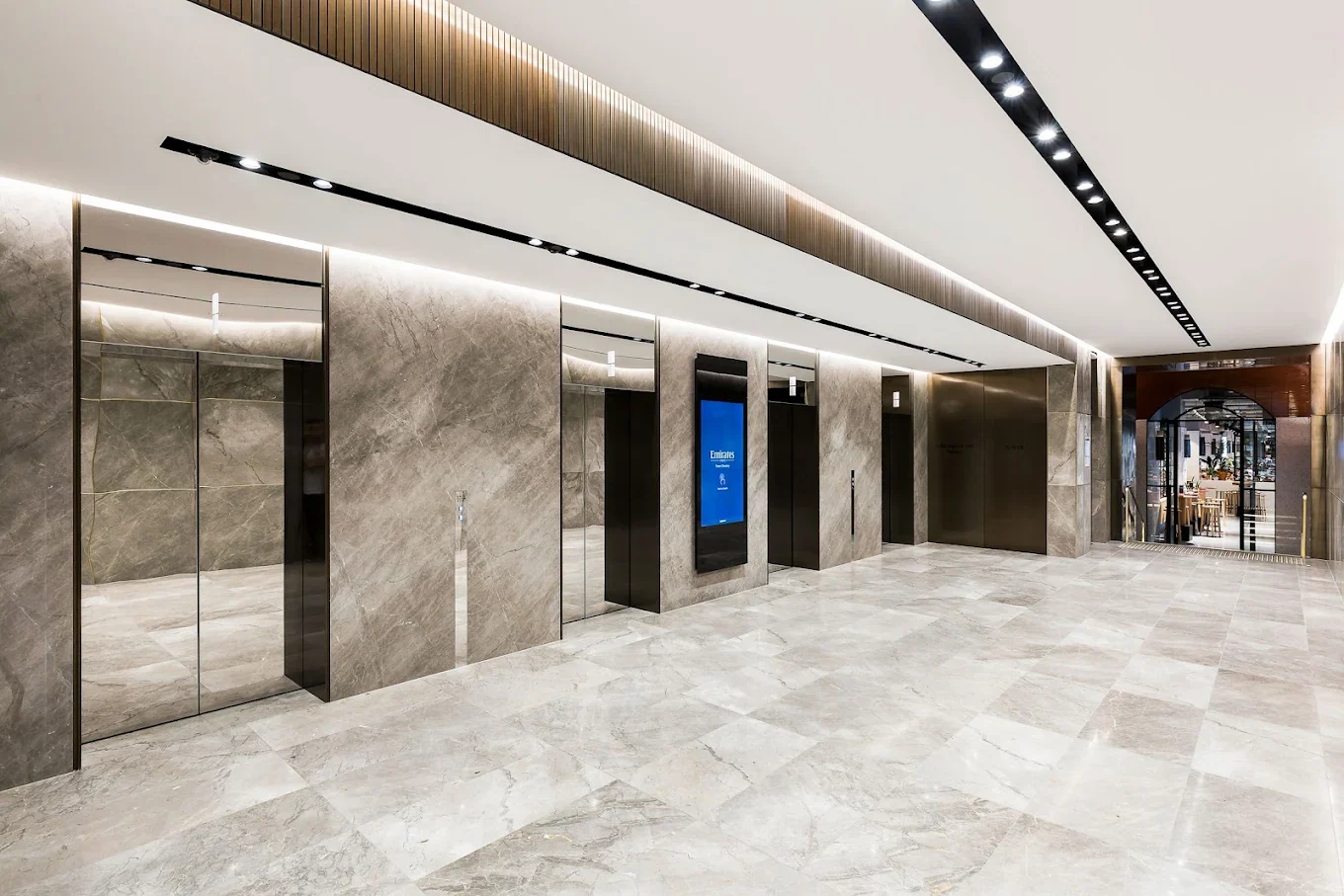 Marble-lined building lobby with lifts at the Collins Street address