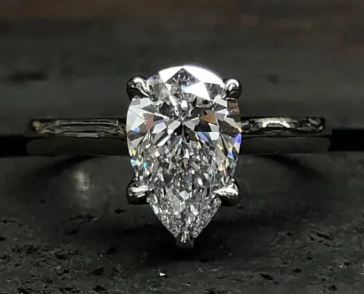 Pear shaped diamond ring on dark background