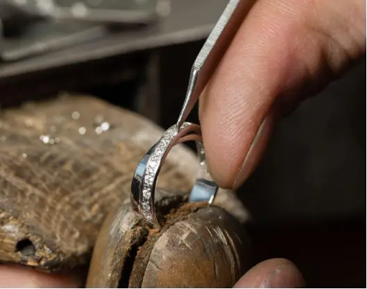 Diamond setter working on a ring